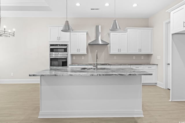 293 Waterfall Cir, Little River, SC 29566 - kitchen featuring wall chimney range hood, double oven, light wood-type flooring, white cabinetry, and recessed lighting