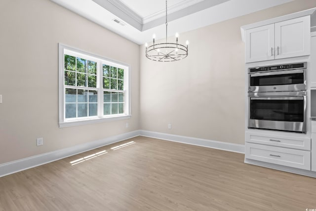 293 Waterfall Cir, Little River, SC 29566 - unfurnished dining area with a chandelier, crown molding, light wood finished floors, and a raised ceiling