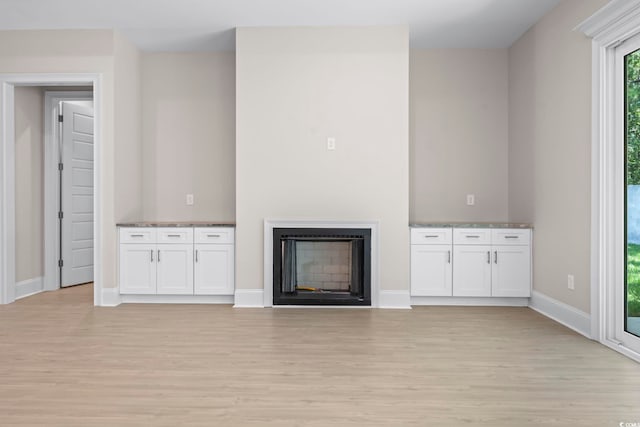 293 Waterfall Cir, Little River, SC 29566 - unfurnished living room with light wood-type flooring and a fireplace
