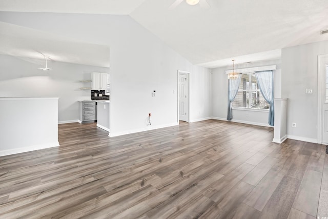 603 Bucks Trl, Longs, SC 29568 - unfurnished living room with vaulted ceiling, a chandelier, ceiling fan, and dark wood-style flooring