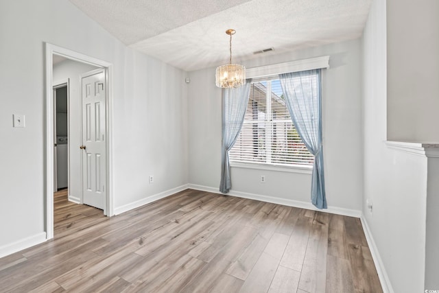 603 Bucks Trl, Longs, SC 29568 - unfurnished room with a chandelier, a textured ceiling, and wood finished floors