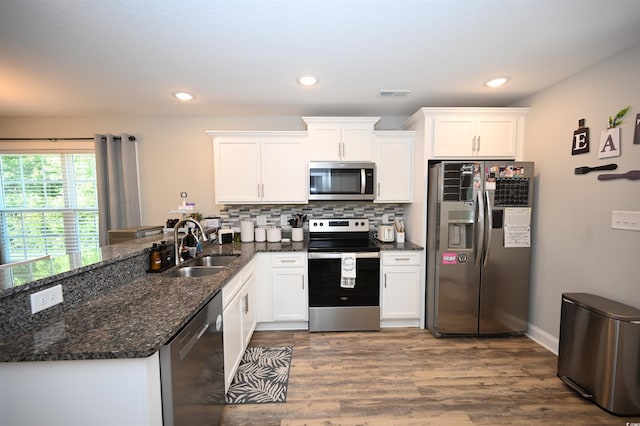 1300 Floyd Page Rd, Galivants Ferry, SC 29544 - kitchen with appliances with stainless steel finishes, a peninsula, white cabinets, wood finished floors, and recessed lighting