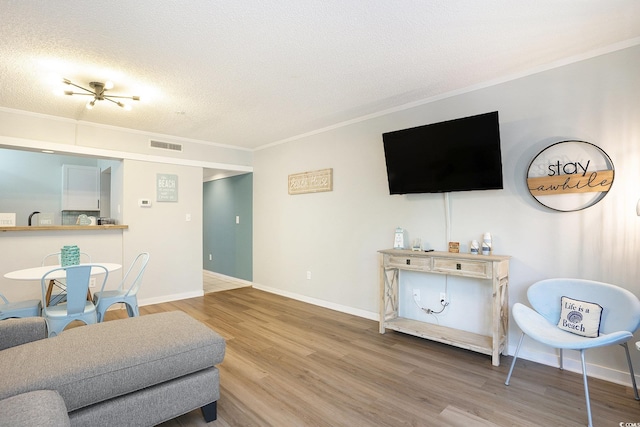 415 Ocean Creek Dr Unit 2208, Myrtle Beach, SC 29572 - living area with crown molding, wood finished floors, and a textured ceiling