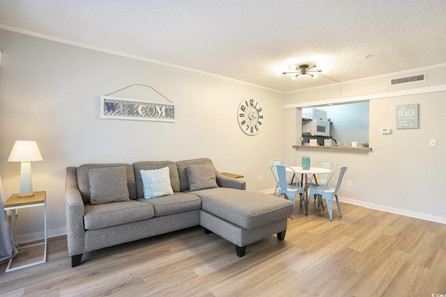 415 Ocean Creek Dr Unit 2208, Myrtle Beach, SC 29572 - living room featuring wood finished floors, crown molding, and a textured ceiling