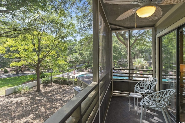 415 Ocean Creek Dr Unit 2208, Myrtle Beach, SC 29572 - sunroom with ceiling fan and view of wooded area