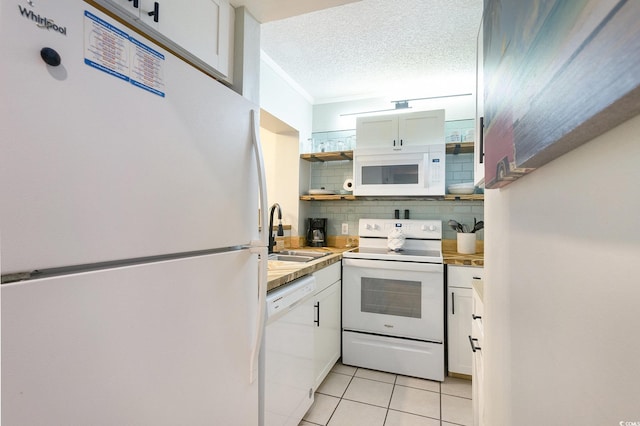 415 Ocean Creek Dr Unit 2208, Myrtle Beach, SC 29572 - kitchen with white appliances, light tile patterned flooring, decorative backsplash, light countertops, and white cabinetry