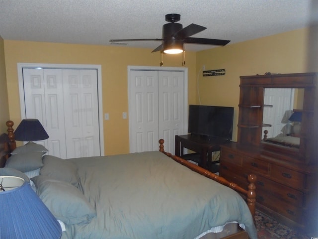 1004 Edge Dr, North Myrtle Beach, SC 29582 - bedroom with multiple closets, a textured ceiling, and a ceiling fan