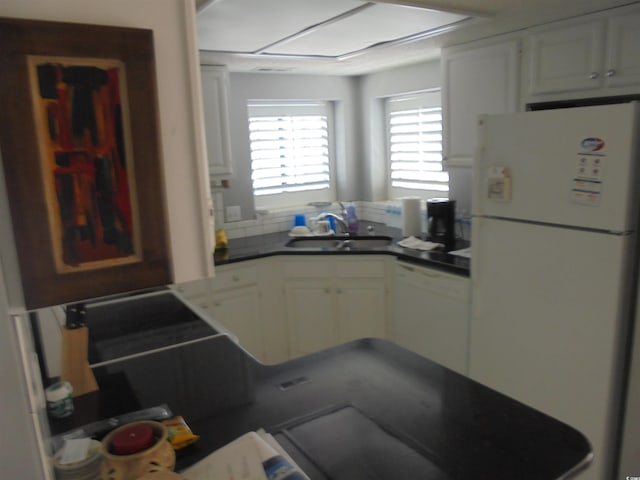1004 Edge Dr, North Myrtle Beach, SC 29582 - kitchen with white appliances, dark countertops, and white cabinetry