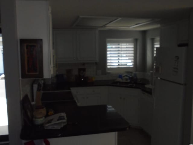 1004 Edge Dr, North Myrtle Beach, SC 29582 - kitchen featuring freestanding refrigerator and dark countertops