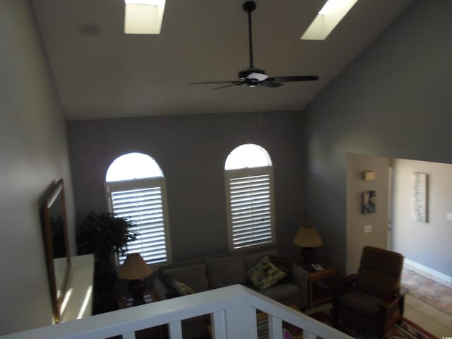 1004 Edge Dr, North Myrtle Beach, SC 29582 - living room featuring high vaulted ceiling, a skylight, and a ceiling fan