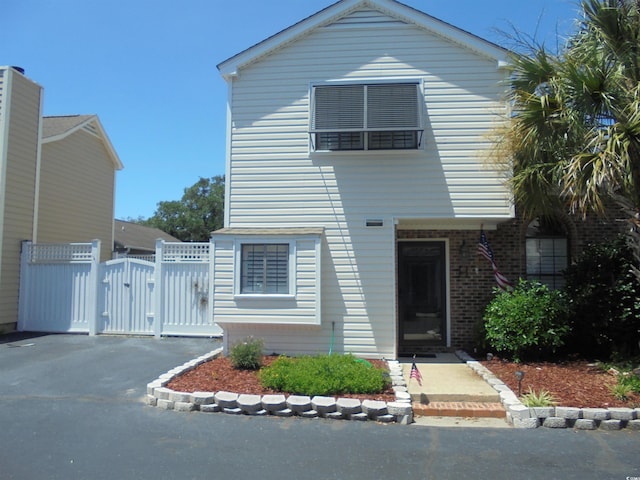 1004 Edge Dr, North Myrtle Beach, SC 29582 - view of front facade featuring a gate and brick siding