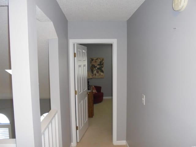 1004 Edge Dr, North Myrtle Beach, SC 29582 - hallway with a textured ceiling, light carpet, and an upstairs landing