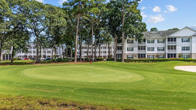 4430 Turtle Ln Unit 2-C, Little River, SC 29566 - surrounding community featuring golf course view, a lawn, and a putting green
