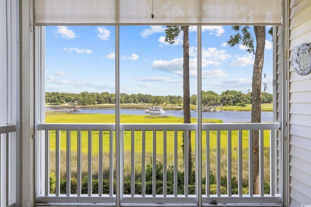 4430 Turtle Ln Unit 2-C, Little River, SC 29566 - unfurnished sunroom with a water view, plenty of natural light, and view of wooded area