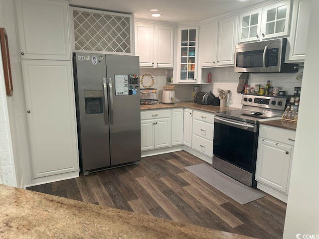 214 Rum Bluff Blvd, Longs, SC 29568 - kitchen featuring appliances with stainless steel finishes, dark wood-type flooring, white cabinets, backsplash, and glass insert cabinets