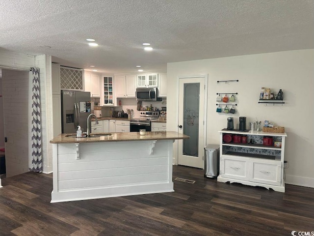 214 Rum Bluff Blvd, Longs, SC 29568 - kitchen featuring stainless steel appliances, dark wood-style floors, white cabinetry, recessed lighting, and a kitchen breakfast bar