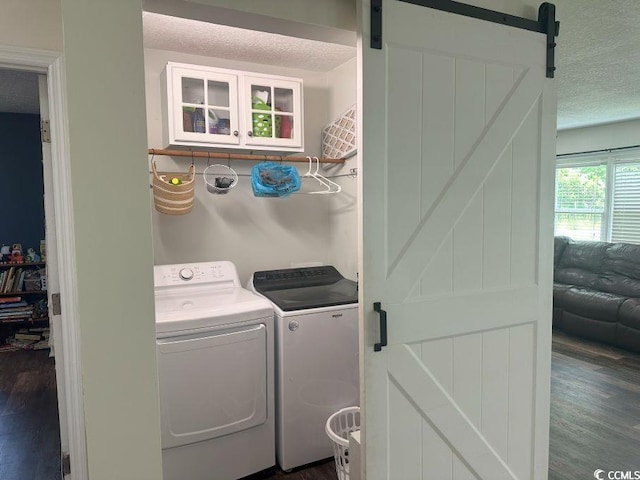 214 Rum Bluff Blvd, Longs, SC 29568 - washroom with a barn door, separate washer and dryer, dark wood finished floors, and a textured ceiling
