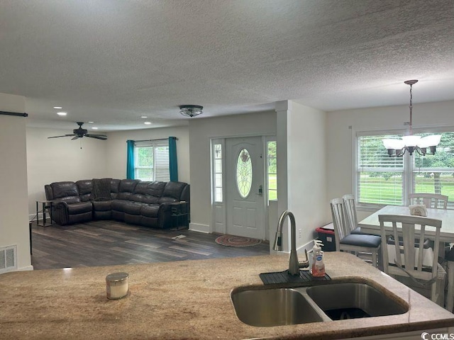 214 Rum Bluff Blvd, Longs, SC 29568 - living room with dark wood-style floors, a chandelier, a textured ceiling, an AC wall unit, and a ceiling fan