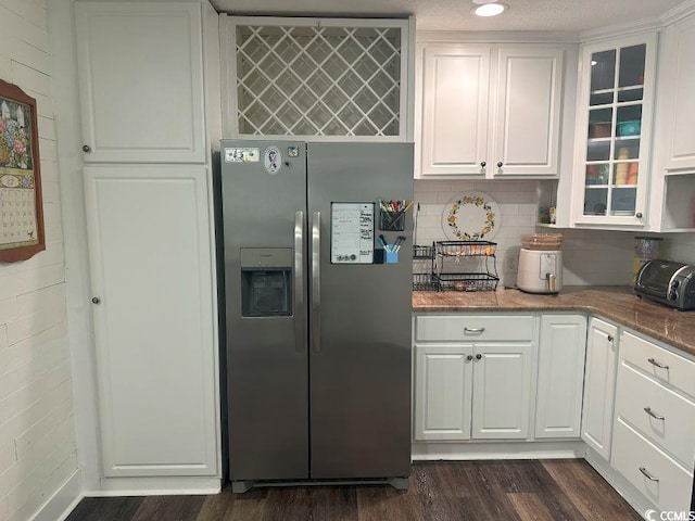 214 Rum Bluff Blvd, Longs, SC 29568 - kitchen with stainless steel fridge, dark wood-style flooring, white cabinetry, and glass insert cabinets