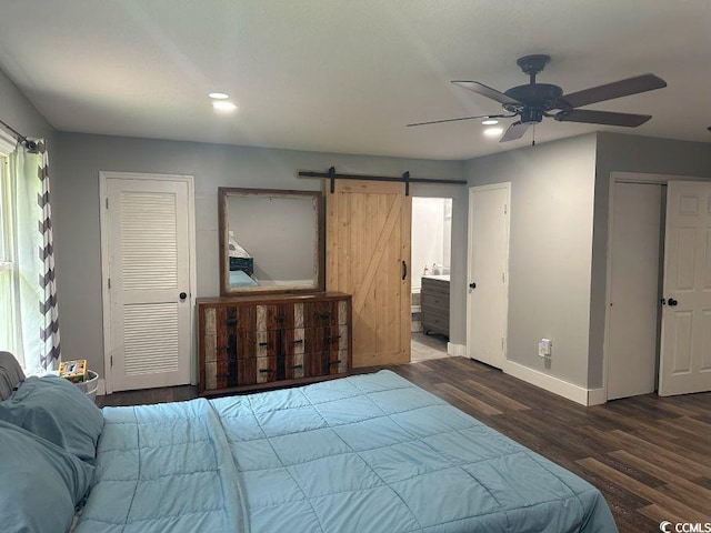 214 Rum Bluff Blvd, Longs, SC 29568 - bedroom with a barn door, wood finished floors, recessed lighting, multiple closets, and a ceiling fan