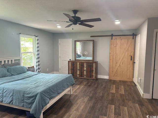 214 Rum Bluff Blvd, Longs, SC 29568 - bedroom with a barn door, dark wood-style flooring, recessed lighting, and ceiling fan