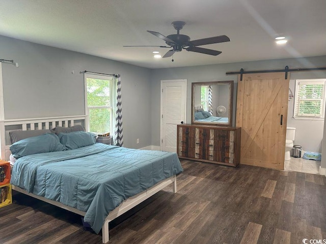 214 Rum Bluff Blvd, Longs, SC 29568 - bedroom featuring a barn door, wood finished floors, multiple windows, and recessed lighting