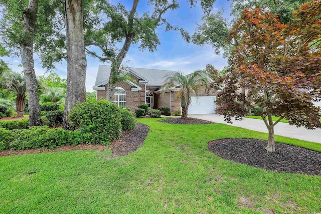 192 Hamby Dr, Pawleys Island, SC 29585 - view of front facade featuring an attached garage, driveway, a front lawn, and brick siding