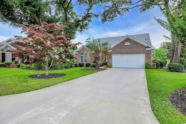 192 Hamby Dr, Pawleys Island, SC 29585 - view of front of property featuring brick siding, driveway, a garage, and a front yard