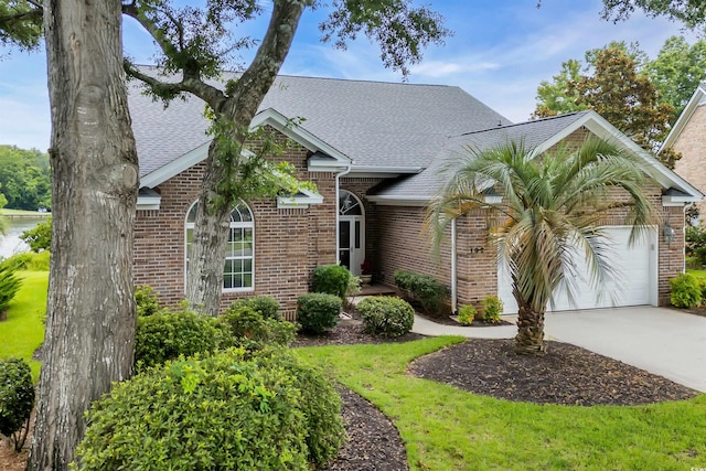 192 Hamby Dr, Pawleys Island, SC 29585 - view of front of home featuring a shingled roof, concrete driveway, a garage, and brick siding
