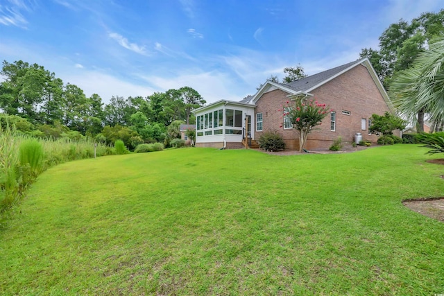 192 Hamby Dr, Pawleys Island, SC 29585 - view of green lawn featuring a sunroom