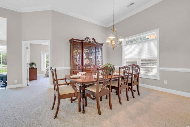 192 Hamby Dr, Pawleys Island, SC 29585 - dining area featuring healthy amount of natural light, a chandelier, light carpet, crown molding, and a high ceiling
