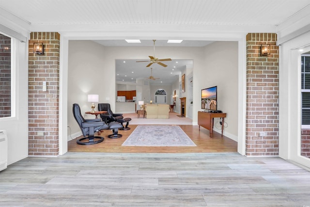 192 Hamby Dr, Pawleys Island, SC 29585 - sitting room featuring brick wall, a skylight, a ceiling fan, and wood finished floors