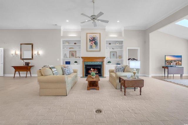 192 Hamby Dr, Pawleys Island, SC 29585 - living area with ornamental molding, ceiling fan, a lit fireplace, built in shelves, and light carpet