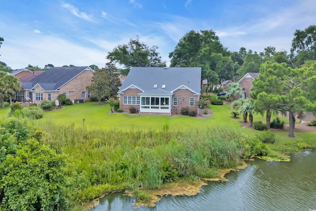 192 Hamby Dr, Pawleys Island, SC 29585 - rear view of house with a sunroom, a lawn, and a water view
