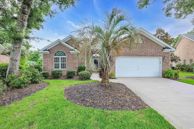 192 Hamby Dr, Pawleys Island, SC 29585 - view of front of house featuring driveway, brick siding, a garage, and a front lawn