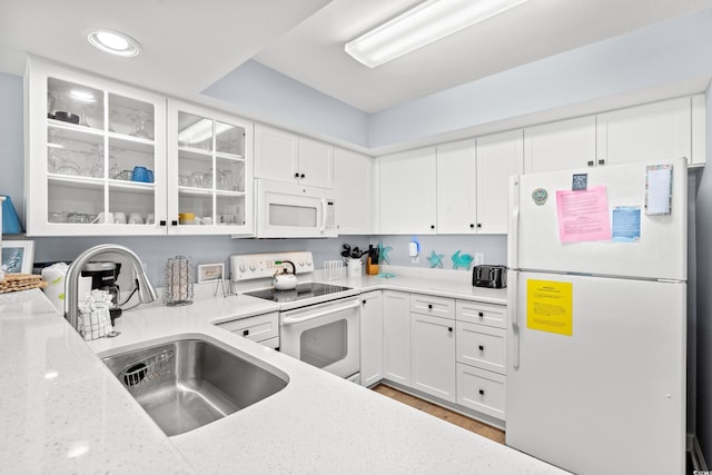 1903 S Ocean Blvd Unit 809, North Myrtle Beach, SC 29582 - kitchen featuring white appliances, light stone countertops, glass insert cabinets, white cabinets, and recessed lighting