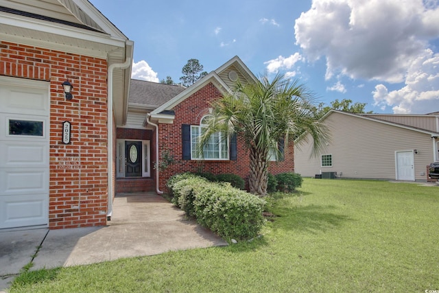 2025 Sawyer St, Conway, SC 29527 - view of front of property with brick siding, a front yard, an attached garage, and a shingled roof