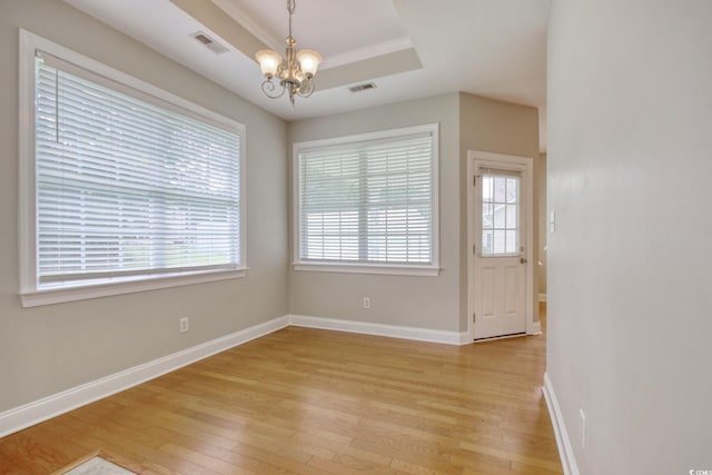 2025 Sawyer St, Conway, SC 29527 - unfurnished dining area featuring light wood-style floors, a chandelier, a raised ceiling, and crown molding