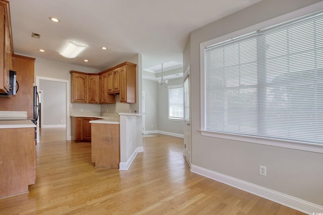 2025 Sawyer St, Conway, SC 29527 - kitchen with light wood-style floors, light countertops, recessed lighting, brown cabinetry, and a peninsula