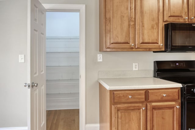 2025 Sawyer St, Conway, SC 29527 - kitchen featuring black appliances, light countertops, wood finished floors, and brown cabinets