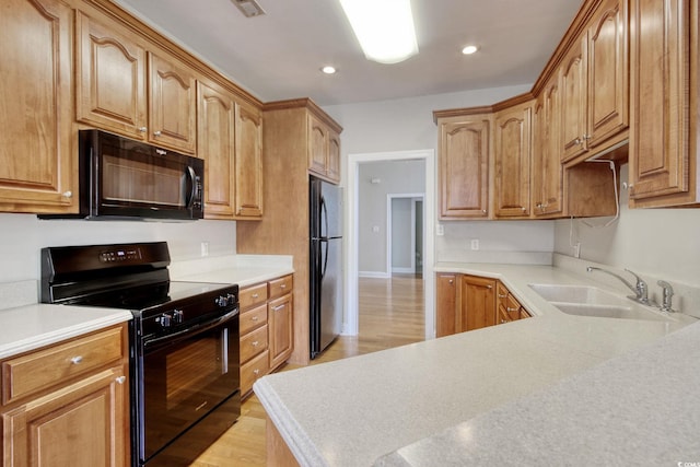 2025 Sawyer St, Conway, SC 29527 - kitchen with black appliances, light wood finished floors, light countertops, and recessed lighting