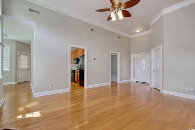 2025 Sawyer St, Conway, SC 29527 - unfurnished living room featuring a ceiling fan, ornamental molding, light wood-style flooring, and a high ceiling