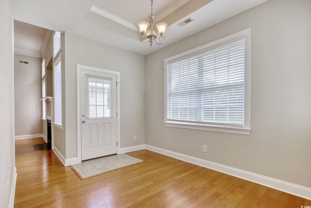 2025 Sawyer St, Conway, SC 29527 - entryway with a chandelier, light wood-style flooring, crown molding, and a tray ceiling