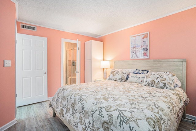 415 Ocean Creek Dr Unit 2373, Myrtle Beach, SC 29572 - bedroom with wood finished floors, crown molding, a textured ceiling, and ensuite bath