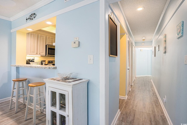 415 Ocean Creek Dr Unit 2373, Myrtle Beach, SC 29572 - hallway featuring ornamental molding, light wood finished floors, a textured ceiling, and recessed lighting