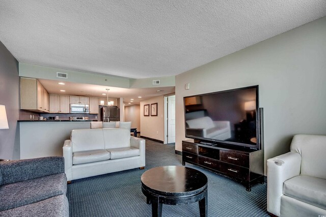 107 S Ocean Blvd Unit 1202, Myrtle Beach, SC 29577 - living area featuring carpet flooring, a textured ceiling, and a chandelier