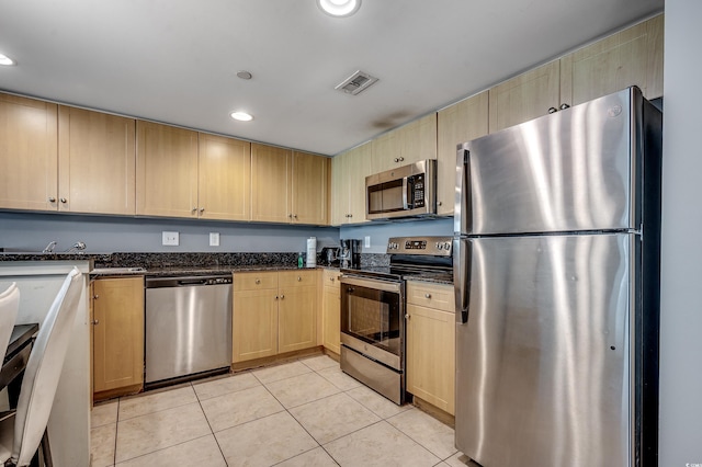 107 S Ocean Blvd Unit 1202, Myrtle Beach, SC 29577 - kitchen featuring appliances with stainless steel finishes, light tile patterned floors, light brown cabinetry, recessed lighting, and dark stone counters