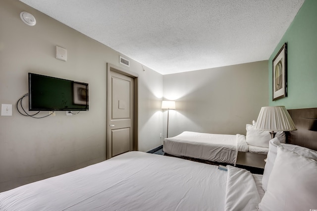 107 S Ocean Blvd Unit 1202, Myrtle Beach, SC 29577 - bedroom with a textured ceiling
