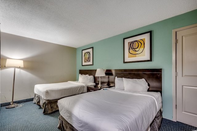 107 S Ocean Blvd Unit 1202, Myrtle Beach, SC 29577 - carpeted bedroom featuring a textured ceiling
