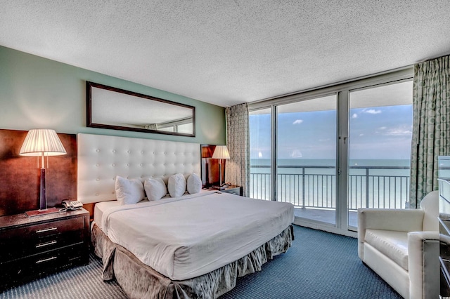 107 S Ocean Blvd Unit 1202, Myrtle Beach, SC 29577 - carpeted bedroom with access to outside, a water view, expansive windows, and a textured ceiling